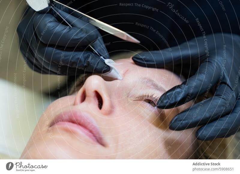 Beautician Performs Microblading Measurements on Client beautician microblading client eyebrow treatment sketch measurement design beauty facial feature