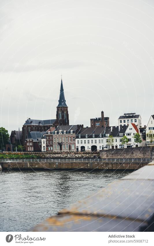 Scenic view of historical architecture along the river in Amsterdam amsterdam netherlands church building water skyline urban scenic traditional cityscape