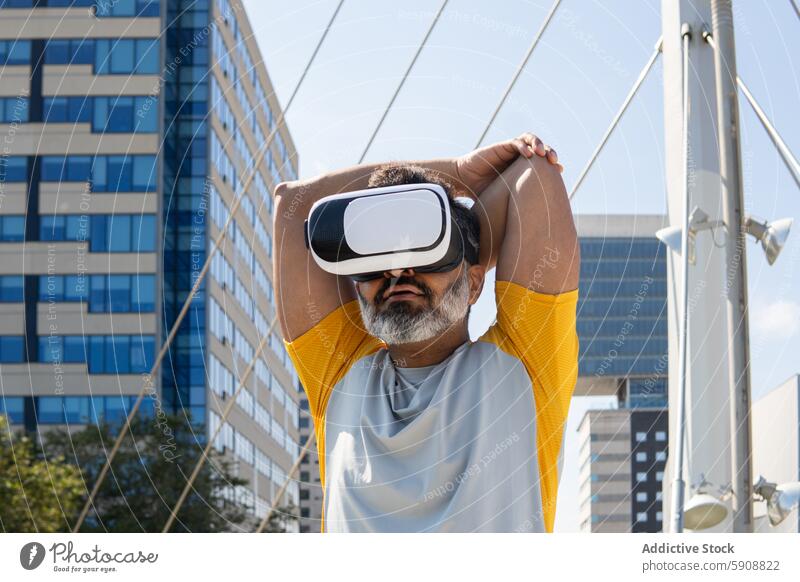 Man in virtual reality headset outdoors in urban setting man city technology experience indian summer gadget device looking at screen immersive cityscape