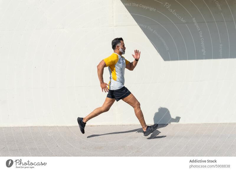 Indian man running during summer sports training indian athlete workout fitness energy dynamic motion outdoor activity exercise healthy lifestyle male jogger