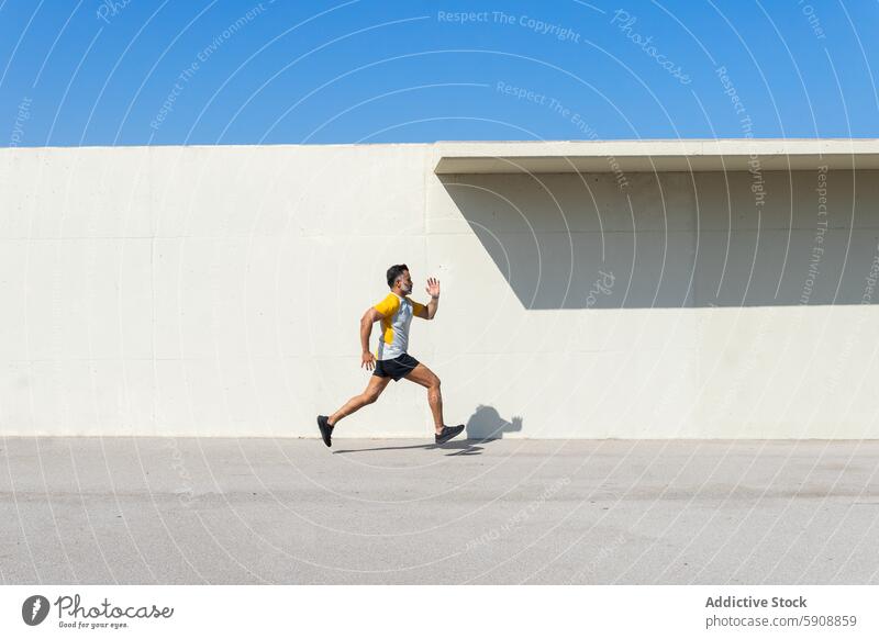 Indian man running during summer sports training indian athlete workout fitness energy dynamic motion outdoor activity exercise healthy lifestyle male jogger