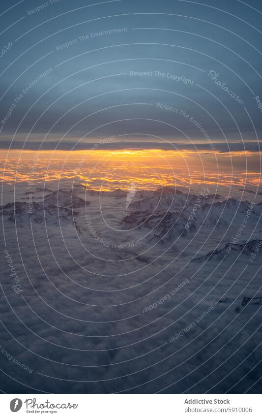 Aerial view of the Swiss Alps during a sunset in winter switzerland alps aerial view snow mountain peak cloud landscape nature beauty scenic tranquil orange