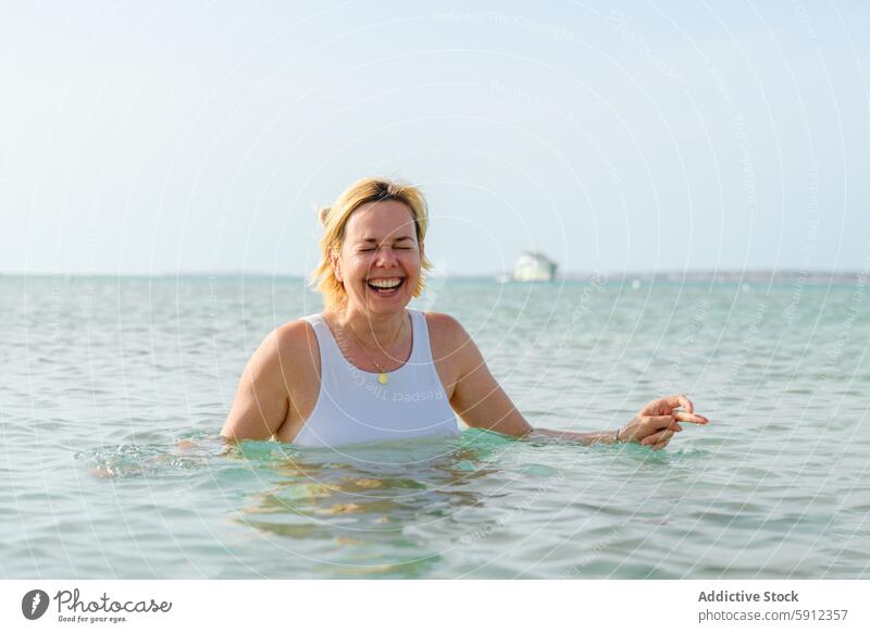 Joyful mother swimming in the sea on Italian beach italian water joy woman happy leisure vacation summer travel outdoor italy coast lifestyle tranquility