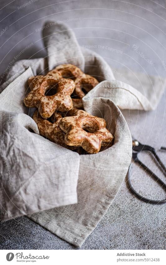 Homemade gingerbread star-shaped cookies in a rustic setting homemade scissors cloth handmade craft baking festive christmas holiday dessert snack treat fabric