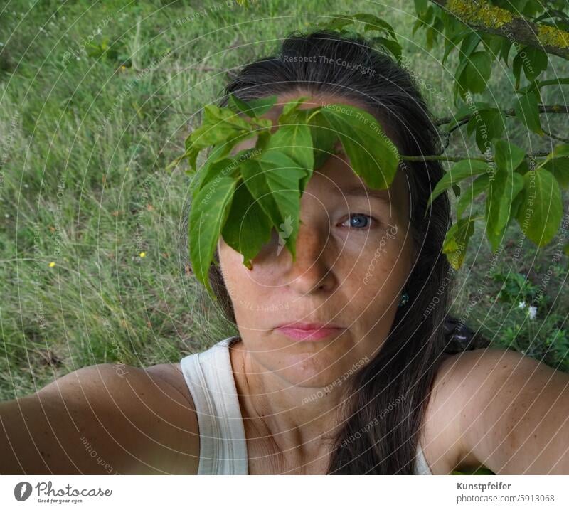 Leaf pirate: upward-looking woman with a natural green eye patch. Green Tree natural beauty Natural environment Nature Woman unostentatious Pirate Life Force