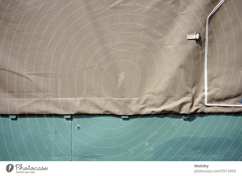 Tarpaulin with rope and eyelets on the loading area of a classic British pick-up and off-road vehicle in olive green at the British Day at Lenkwerk in Bielefeld in the Teutoburg Forest in East Westphalia-Lippe