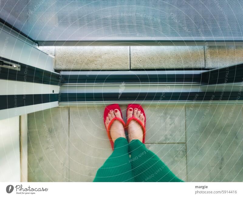 Female feet with red flip-flops stand in the doorway Flip-flops Feet on the ground feminine Feet together Human being Nail polish Toes Legs Sliding door