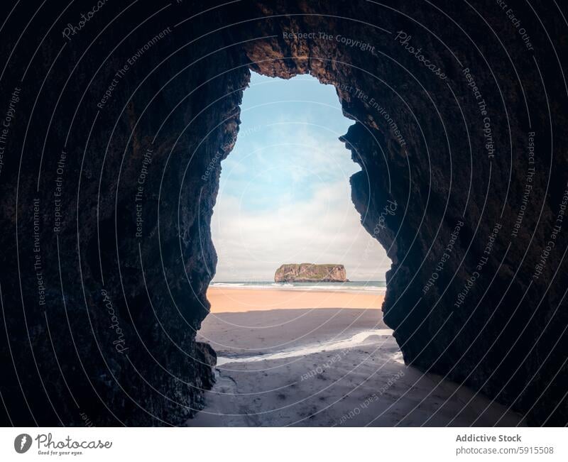 Stunning view through a cave at Llanes beaches in Asturias asturias llanes playa de andrin rock ocean sand shore landscape coast coastal sea limestone horizon