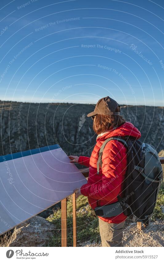 Side view of an unrecognizable woman birdwatching in Salamanca side view anonymous faceless hiking lookout salamanca spain map examining outdoor gear nature