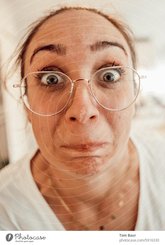 Woman with glasses looks into the camera with wide eyes Eye contact open one's eyes Eyeglasses portrait Feminine Face Human being Adults Looking into the camera