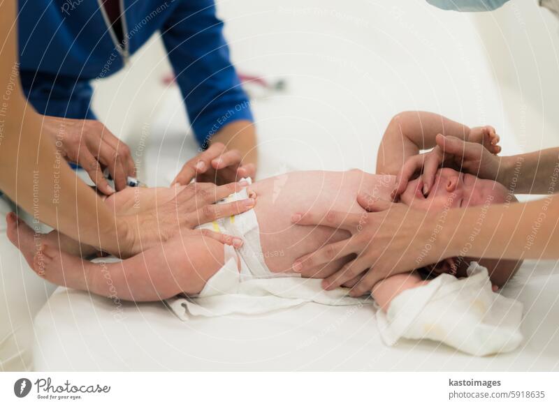 Baby beeing vaccinated by pediatrician in presence of his mother. Preventive vaccination against Diphtheria, whooping cough, tetanus, hepatitis, haemophilus influenzae, pneumococcus, poliomyelitis