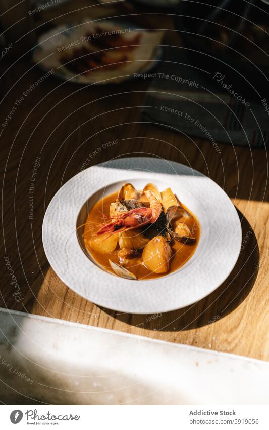 Exquisite seafood stew in sunlight on elegant white plate shrimp mussels sunlit gourmet texture dish presentation sophistication cuisine culinary meal dinner