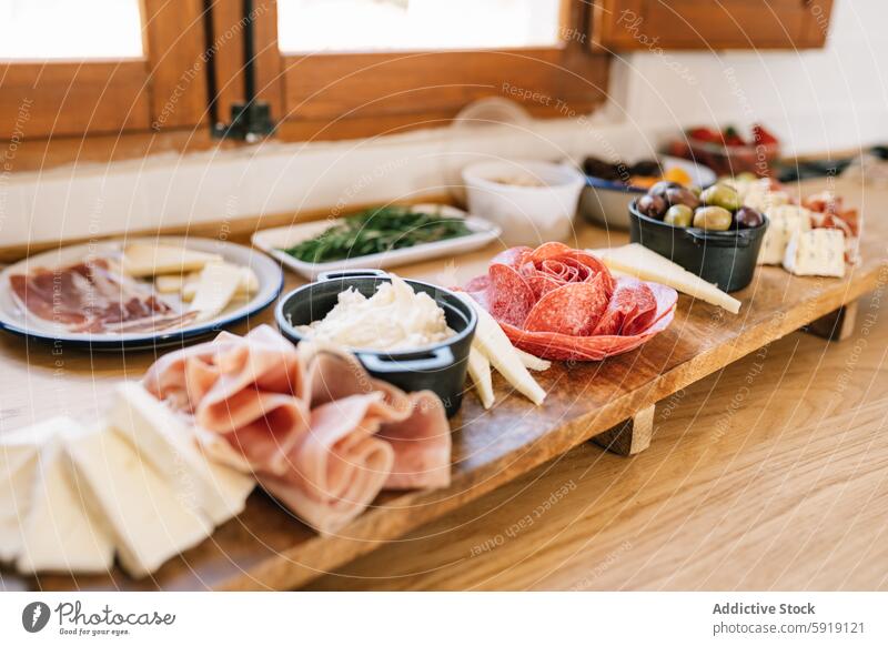 Gourmet food spread on a wooden table gourmet cheese cured meat olive vegetable fresh arrangement board snack platter variety mixed tasty delicious entertaining