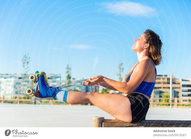 Young woman enjoying a roller skating break in outdoor park roller skate skate park sunny happiness active lifestyle lace up vibrant colorful young leisure