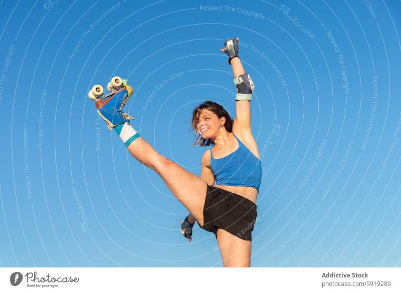 Enthusiastic young girl enjoying roller skating against clear sky roller skate skate park sport fitness outdoor blue sky youth leisure activity enjoyment fun