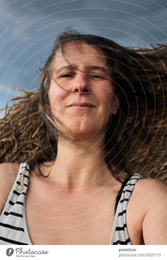 a thunderstorm approaches. woman in front of bales of straw and dark clouds Dark clouds windy stormy anxious Bale of straw Agriculture Woman