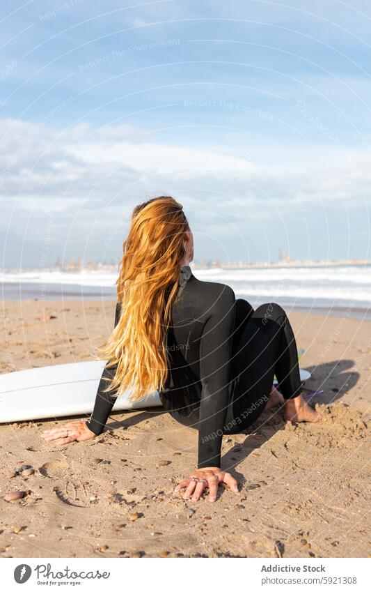 Unrecognizable woman near surfboard on seashore coast hobby activity pastime sport water tide wave waterfront sand seaside nature equipment summer sunlight