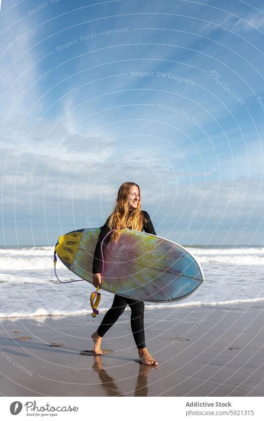 Woman with surfboard walking on wet beach woman coast shore hobby activity pastime sport sea water tide wave waterfront seaside nature seashore equipment summer