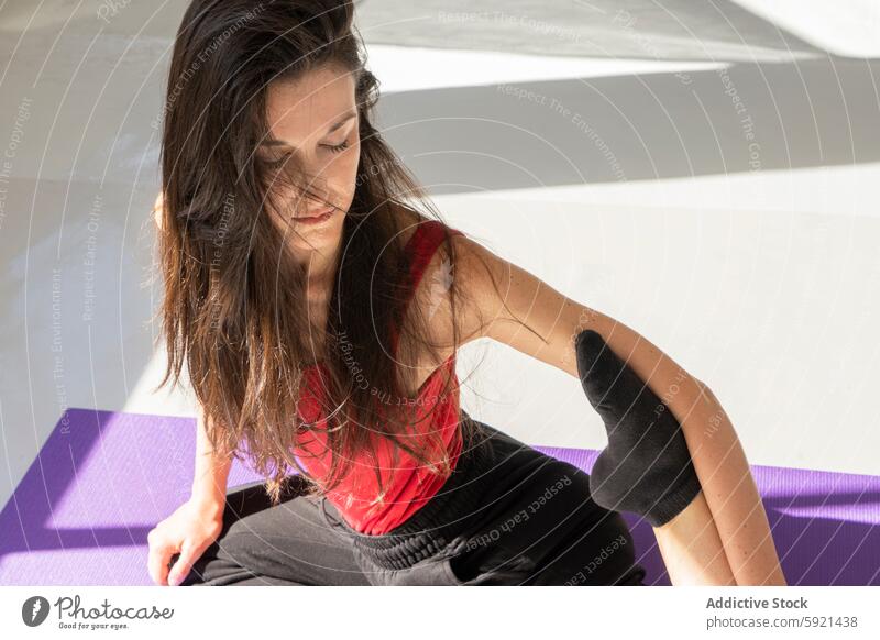 Woman in pose during yoga session indoors woman meditation contemplation peaceful serenity focus casual comfort clothing expression young female mat exercise