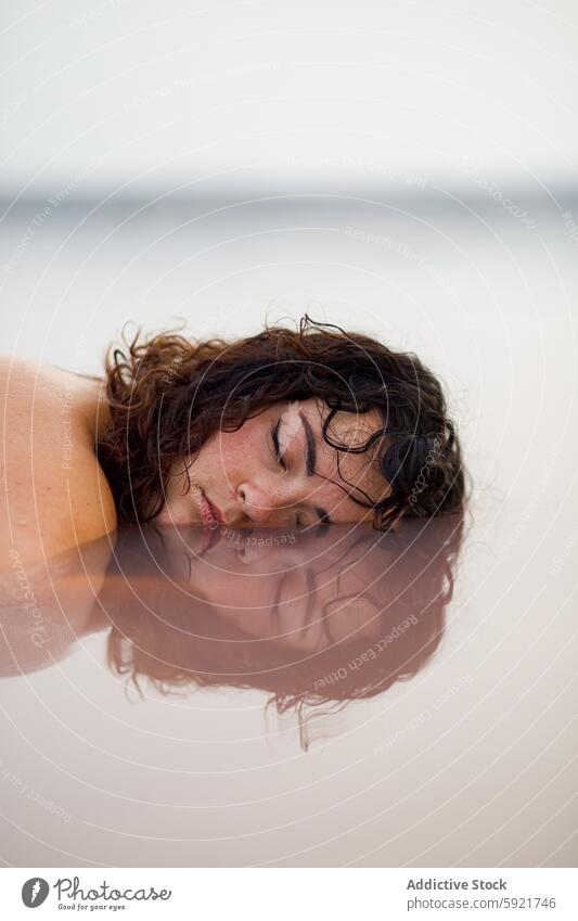 Dreamy woman with face in water of lake pink half serene dreamy pond eyes closed female peaceful tranquil lying calm harmony summer fresh nature tender pure