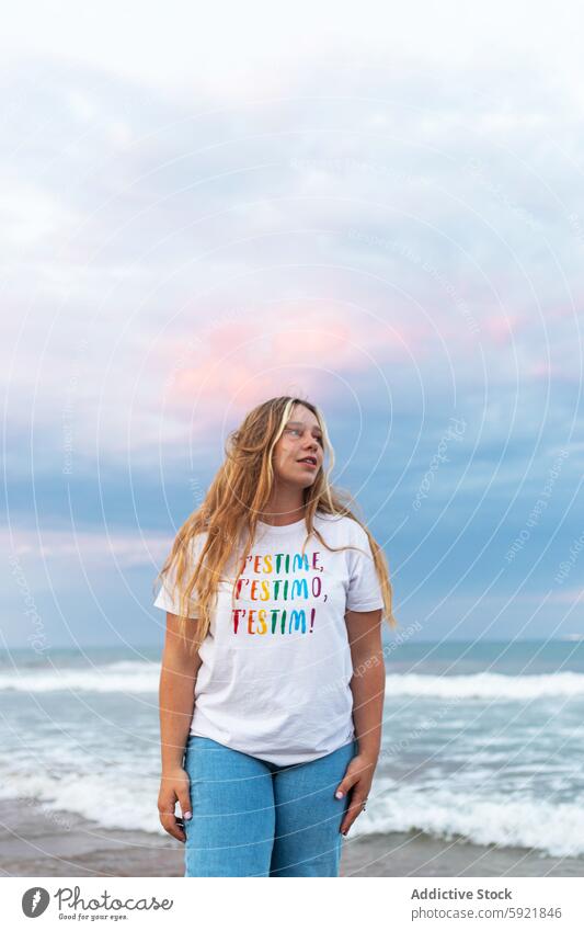 Content stylish woman standing on beach in sunset style young trendy summer positive sea seaside female happy cheerful confident seashore coast evening