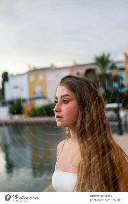 Charming young woman in city in evening tropical embankment sunset charming tranquil summer female calm style street enjoy long hair trendy serene exotic urban