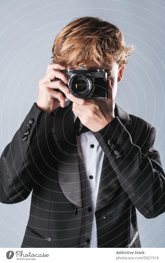 Preteen boy taking photo with camera in studio kid suit photo camera formal child preteen take photo outfit positive device schoolboy little moment classy