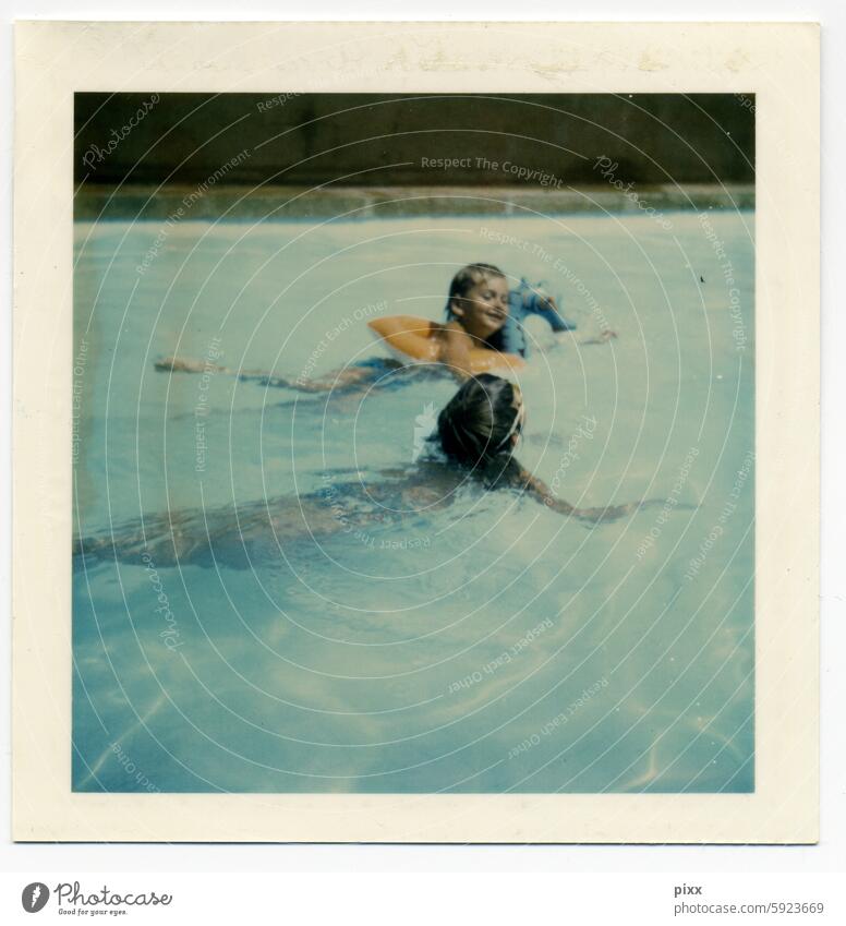 Polaroid of two children aged between 4 and 7 practicing swimming in a pool. One of the children is wearing a swimming tire that is supposed to represent a seahorse.