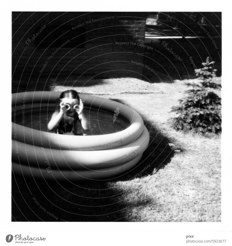 SW Polaroid of child in an inflatable swimming pool sandra fax grimace Hide Black & white photo Original Swimming & Bathing swimming pools Swimming goggles eyes