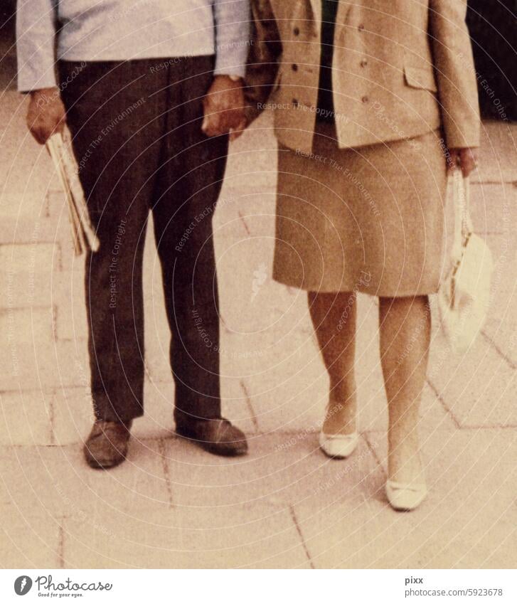 Photo from the 60s with a couple holding hands Costume Handbag pumps Daily newspaper Married couple Couple Under HandinHand Beige light blue chic Going out