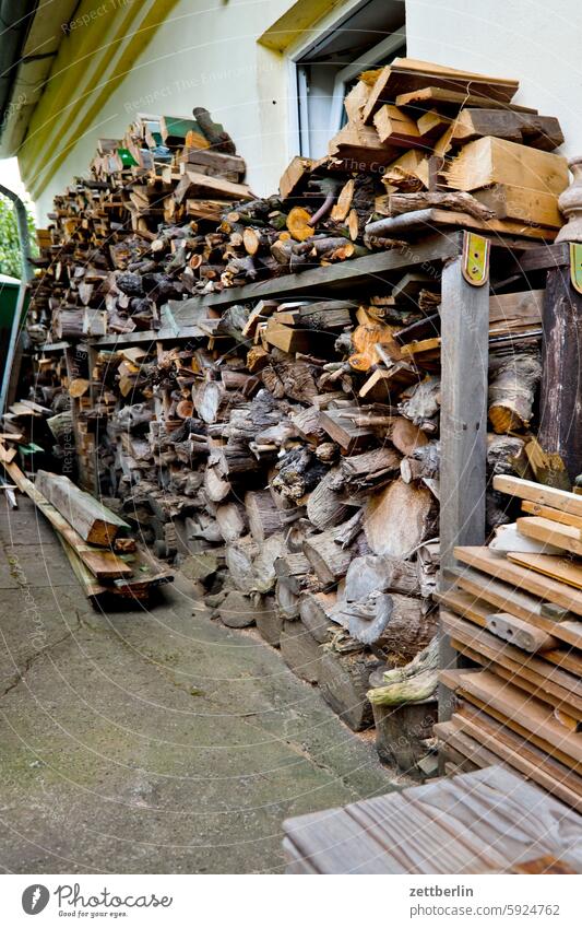 Wood behind the hut Firewood firewood lumber Shelves wooden rack clever board boards log Logs Joist Heating by stove incineration Renewable raw materials co2