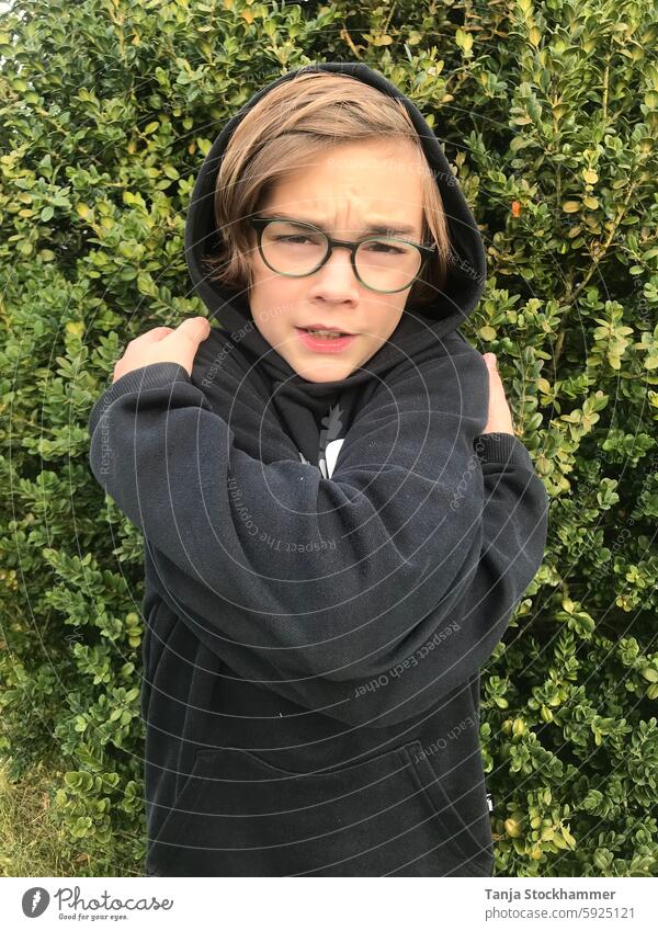 Boy hugging himself Boy (child) Embrace boy like Self-Love Person wearing glasses blonde hair Exterior shot Black green background Human being