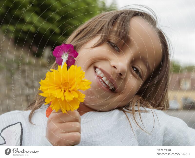 portrait of girl smiling with a bouquet of flowers smile happiness yellow purple childhood beautiful happy young pretty lifestyle beauty face joy adorable