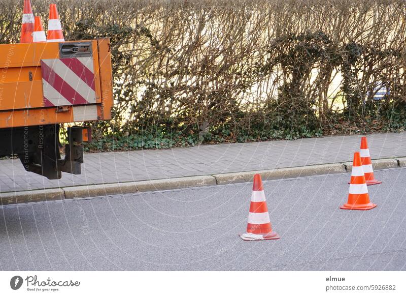 Footpath and road barriers with traffic cones cordon guiding cone Pylon traffic caps Street road closure Warning caps Hats Blog Reddish white Traffic watch