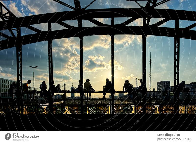 Silhouettes of young people sitting on the steel bridge in the sunset Full frame Hacker Brücke ancient architecture backgrounds building central Europe city