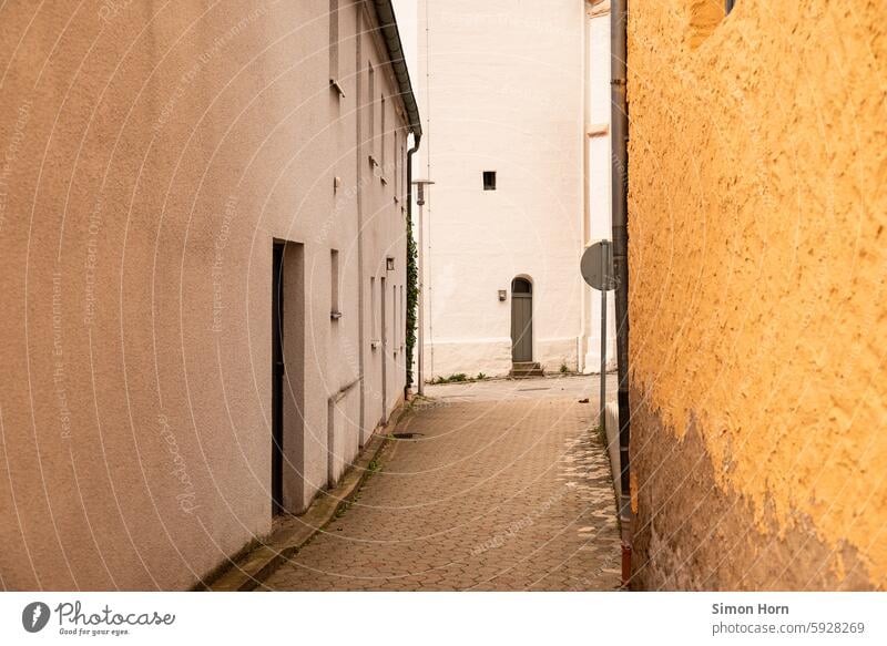 narrow alley leads to a church building Alley Small Town Narrow Church Old town Development city centre downtown Historic Architecture