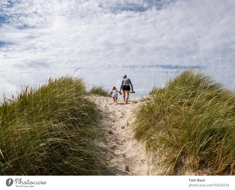 Mother and daughter hand in hand in the dunes stage Girl power Woman Child Mother with child Landscape Infancy maternity Family & Relations