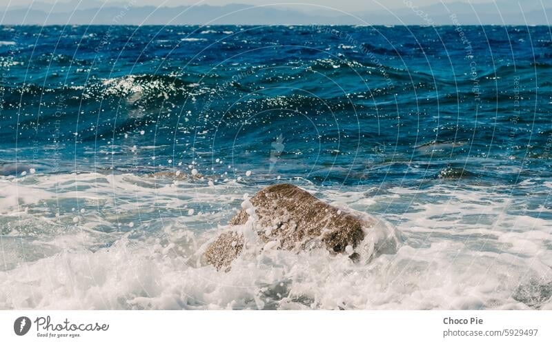 waves and splashes of sea surf and stones on the seashore in Egypt Dahab South Sinai Red Sea blue blue water detailed exotic foam horizon landscape mountains