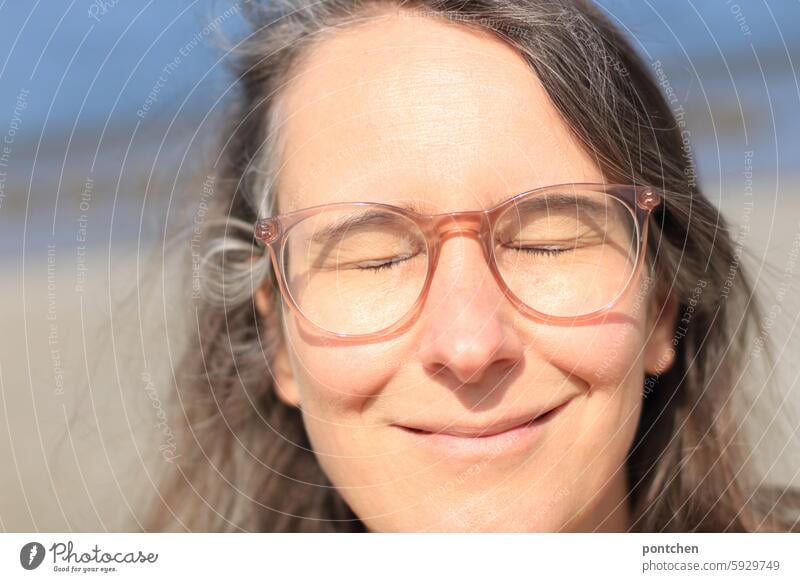 close your eyes, it's blinding. Sun Dazzle Protection eyes closed Sunbeam Bright Woman Eyeglasses Light Back-light Exterior shot Smiling