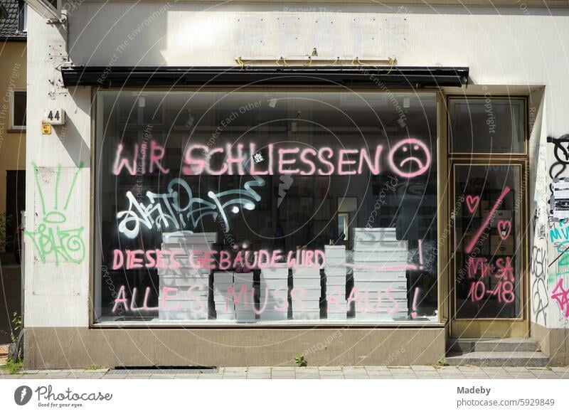 Business closure of a store and business with cardboard box in the shop window of an old building in natural colors in summer in the sunshine in the old town of Münster in Westphalia in Münsterland