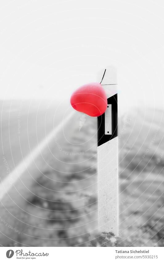 Boundary post in the fog, hung with a red balloon heart limiting pillar Boundary posts red heart Balloon Fog Mystic Red Black & white photo Cold Exterior shot