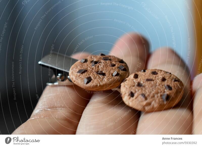 Hand holding a handmade hairpin with miniature clay cookie Polymer Hairpin Hairclip Miniature macro closeup Craft art Cookies handcrafted chocolate chips