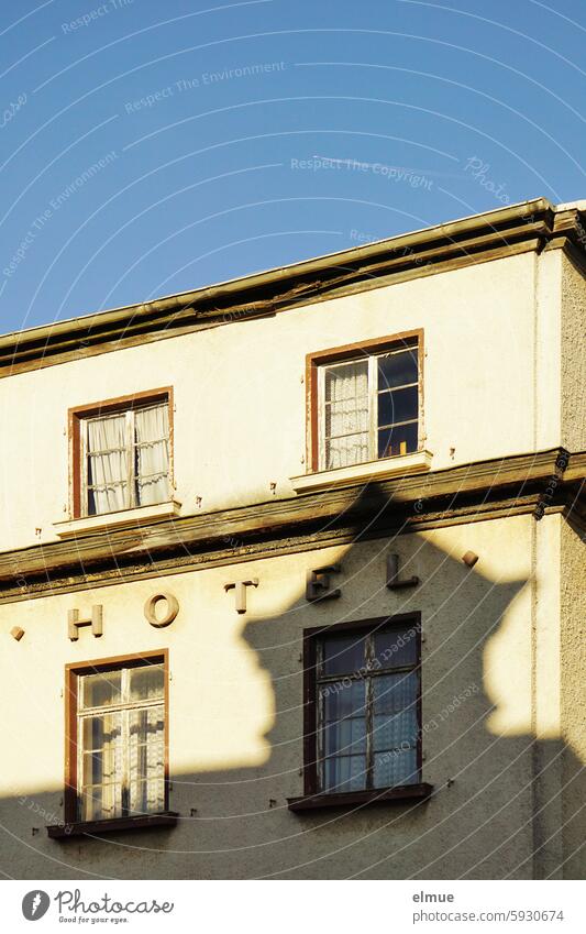 HOTEL lettering on a dilapidated building Hotel lost places Accommodation overnight Window Shadow dwell forsake sb./sth. Uninhabited Blog Sleep Past Decline