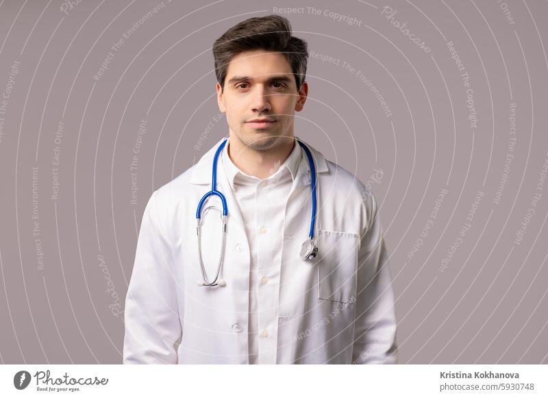 Portrait of serious handsome mature doctor man in medical coat on white studio confident person male people portrait formal looking face indoor workplace ceo