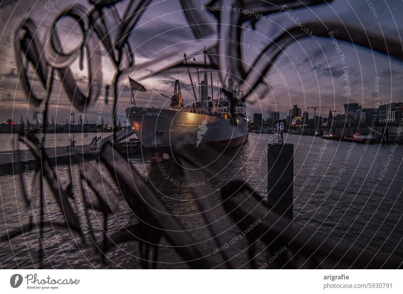 Museum ship Cap San Diego in the port of Hamburg during the blue hour behind a pane of glass covered in graffiti cap san diego port romance Port of Hamburg