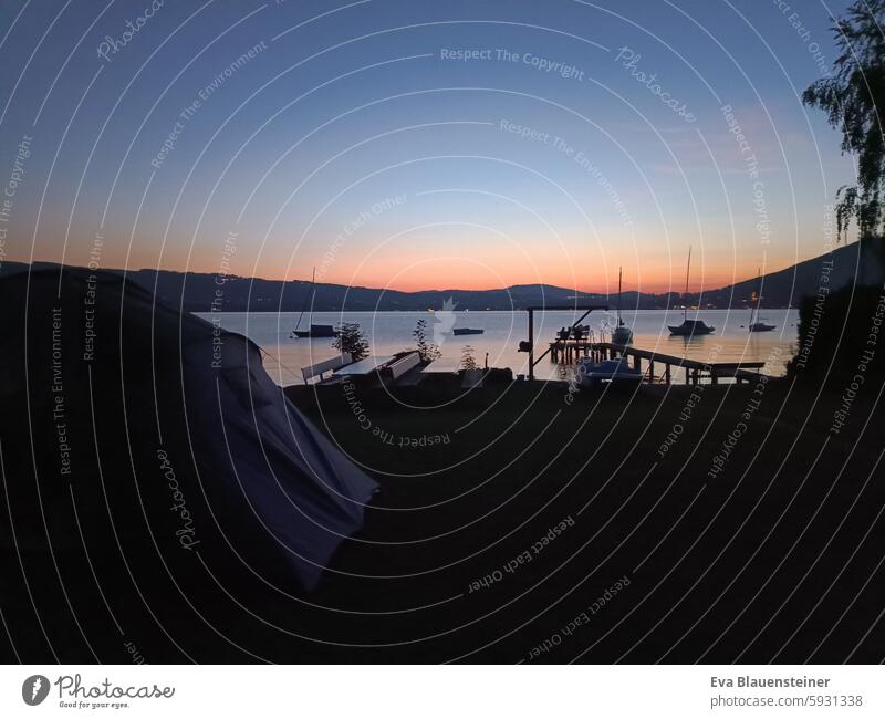 Tent in the sunset by the lake with boats and jetty Night sky Lake Lake Attersee Salzkammergut Sailboat Summer night Evening Milky way Sky Canopy of stars Water