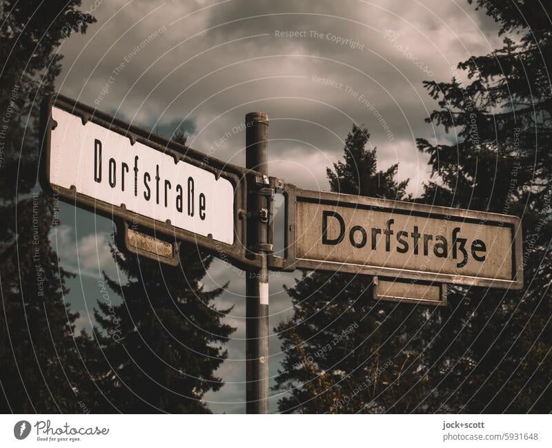 End and beginning of Dorfstraße Village road Street sign Word double Signs and labeling Traffic infrastructure