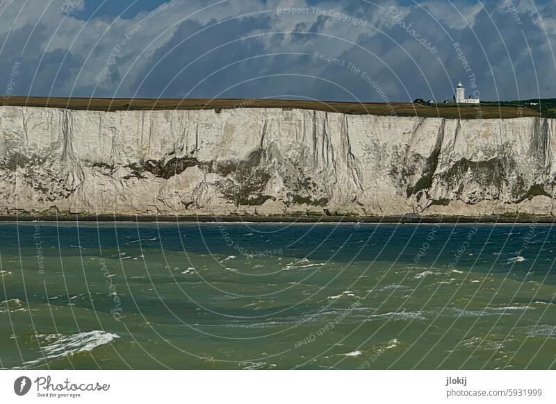 Chalk cliffs with lighthouse uk Great Britain England Dover Water Channel Ocean Lake Rock Waves Clouds Wind vacation Exterior shot coast Nature Sky Environment