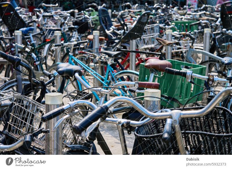 Many bicycles parked at a public bike rack in Copenhagen city parking street commuting copenhagen cycling eco friendly transportation urban sidewalk traditional