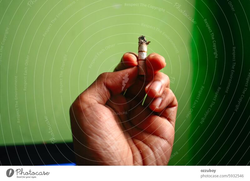 close up of hand holding a clove cigarette close-up human hand adults only smoking - activity smoking issues unhealthy living addiction part of bad habit